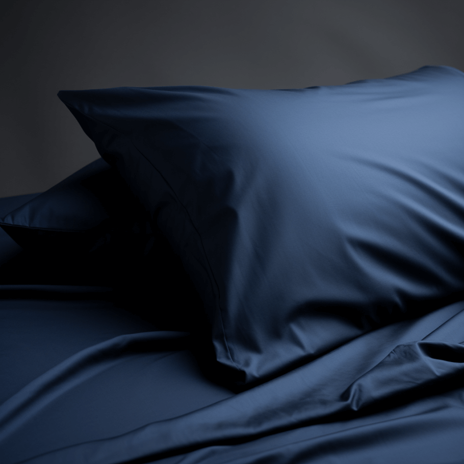 A bed with navy blue cotton bedding set on it showcasing 1 pillowcase by Ebb and Weave