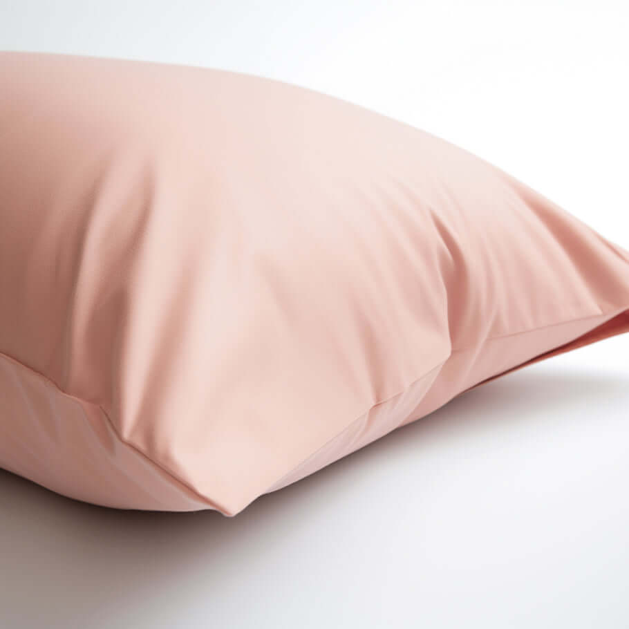 An Ebb & Weave Blush Pink Luxury Egyptian Cotton Housewife Pillowcase on a white surface.