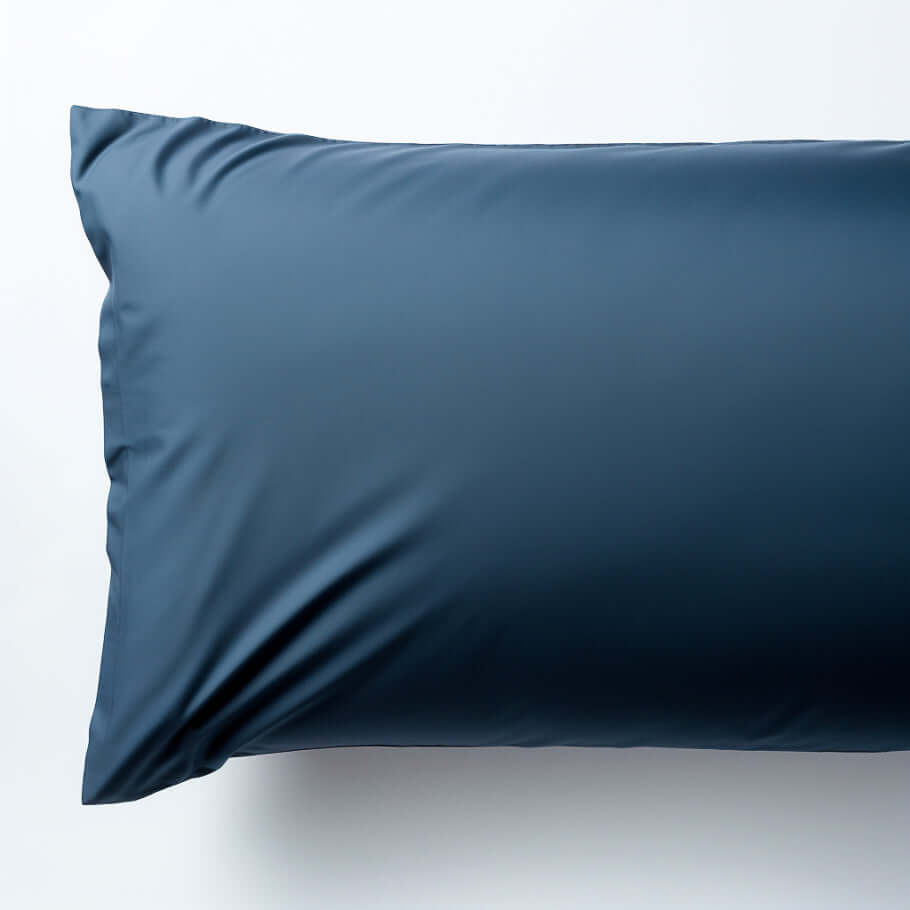 An Ebb & Weave Navy Blue Luxury Cotton Sateen Housewife Pillowcase on a white background.